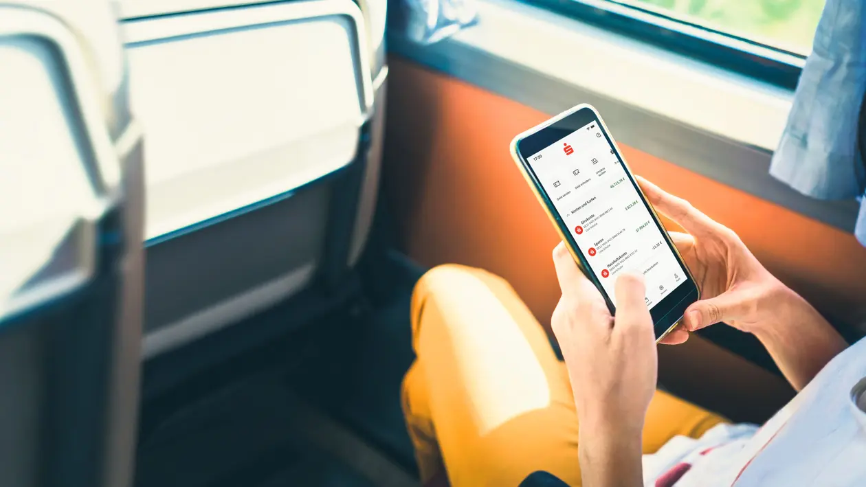 Person holding credit card while shopping online